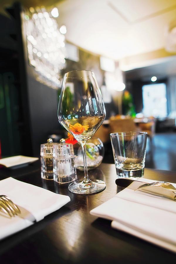 Interior Of The Restaurant, Focus On A Wine Glass Photograph by Jan Prerovsky