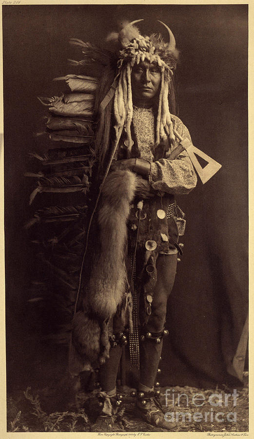 Portrait Photograph - Iron Brest, Piegan. Costume Of A Member Of The Bulls, A Former Society That Has Disappeared For Many Years Photo From Volume 6 Of The Encyclopedia Published By Edward S. Curtis by Edward Sheriff Curtis
