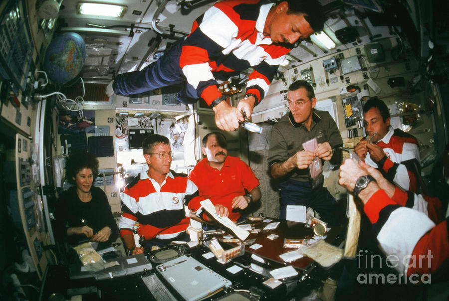 Iss Astronauts Eating Photograph by Nasa/science Photo Library