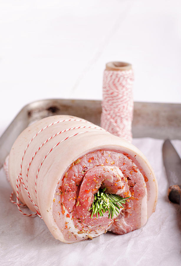 Italian Chili And Fennel Porchetta rolled Pork Belly Ready For The Oven Photograph by Jamie Watson