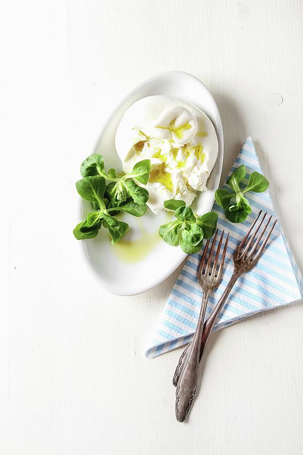Italian Fresh Burrata Cheese In A Ceramic Mash With A Green Salad Photograph by Naltik
