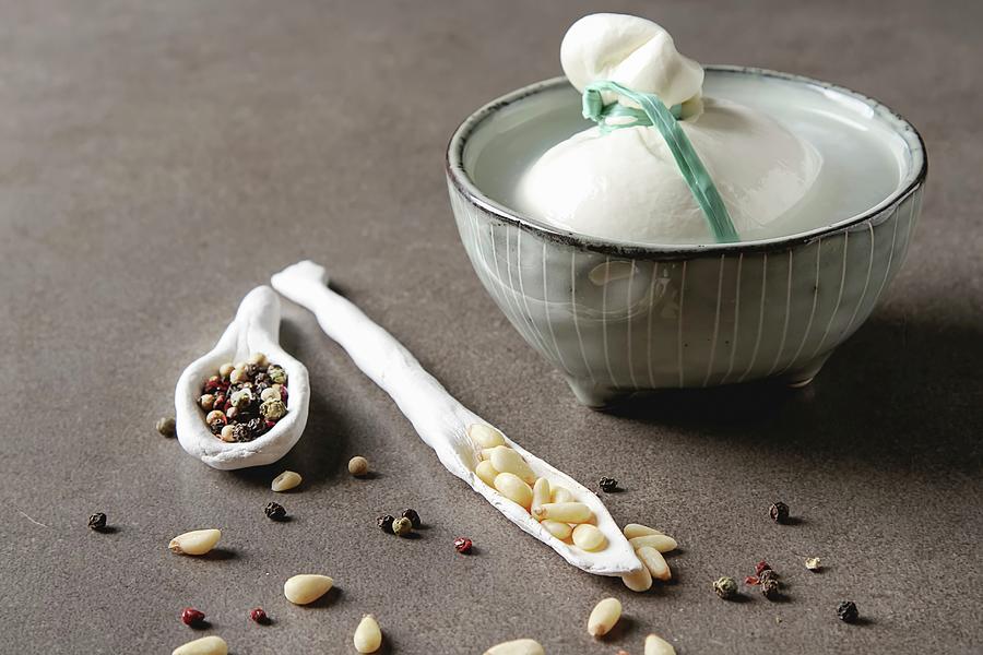 Italian Fresh Burrata Cheese In A Ceramic Mousse With Spices And Pine Nuts Photograph by Naltik