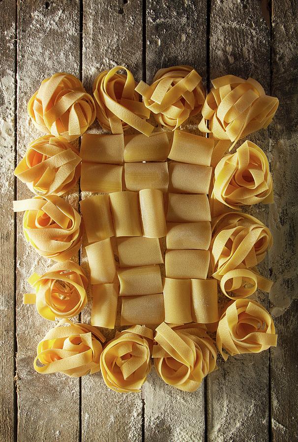 Italian Pastas With Flour On A Wooden Table Photograph by Valeria Aksakova