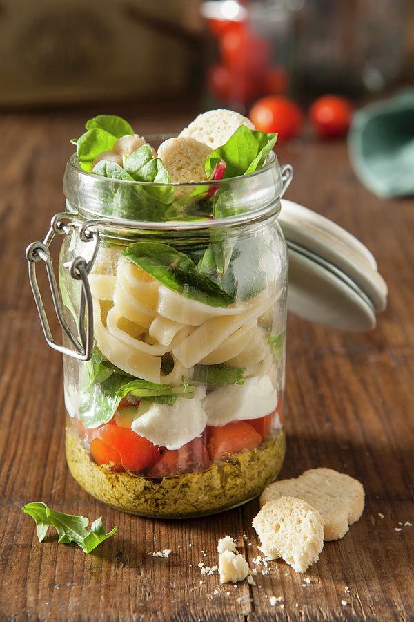 Italian Pesto Pasta Vegetarian Lunch Jar In A Rustic Setting Photograph by Stacy Grant