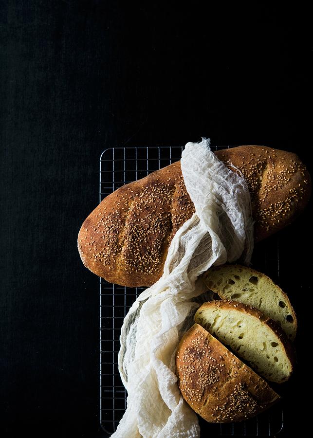 Italian Semolina Bread On A Cooling Rack Against A Black Background Photograph by Lisa Rees