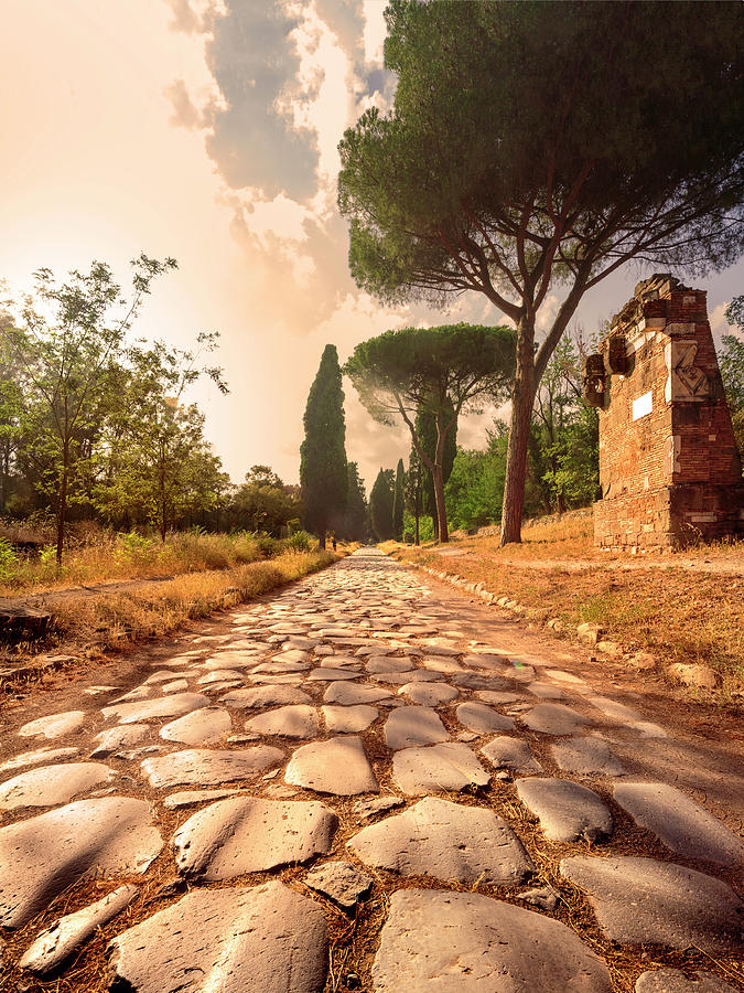 Sunset Digital Art - Italy, Rome, Appian Way, Via Appia Antica. Historic Cobblestone Ancient Roman Road Backlit. Evening Sunset Lights by Paolo Giocoso