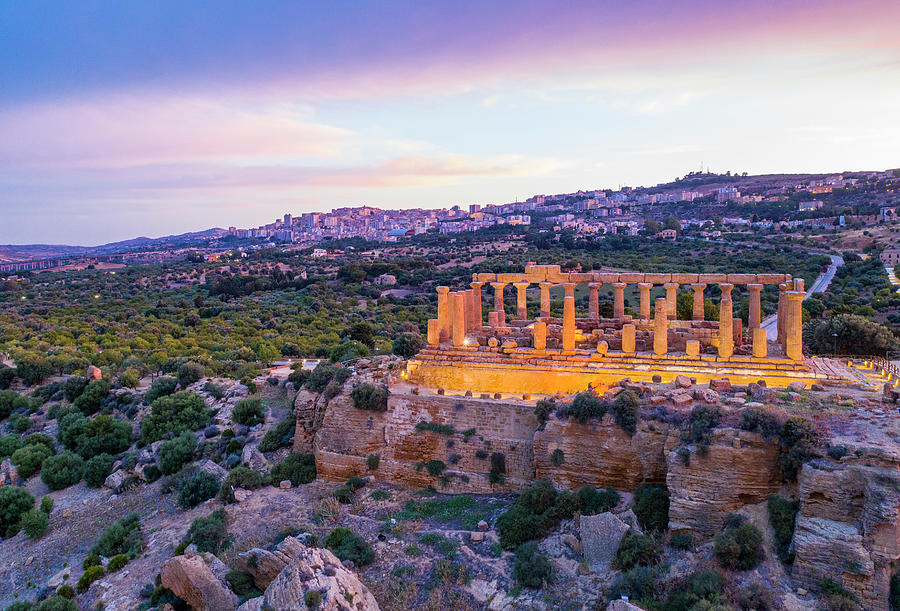 Italy, Sicily, Agrigento District, Agrigento, Valley Of The Temples, City Of Agrigento And The Temple Of Juno On The Temples Valley At Blue Hour Digital Art by Manfred Bortoli