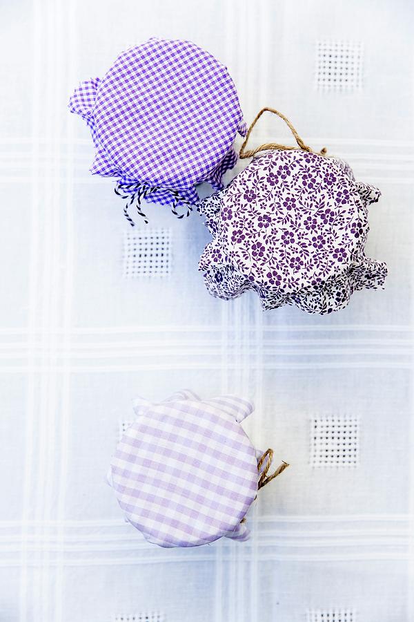 Jam Jars With Various Fabric Decorations Photograph by Claudia Timmann