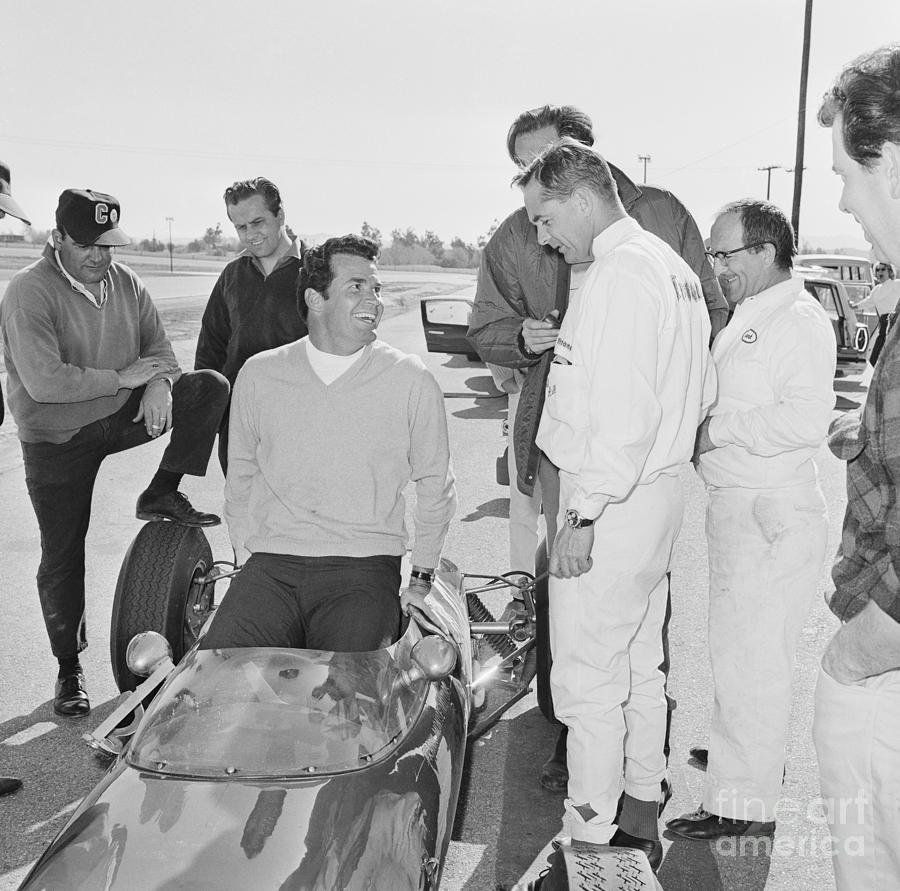 James Garner Slipping Into A Race Car Photograph by Bettmann