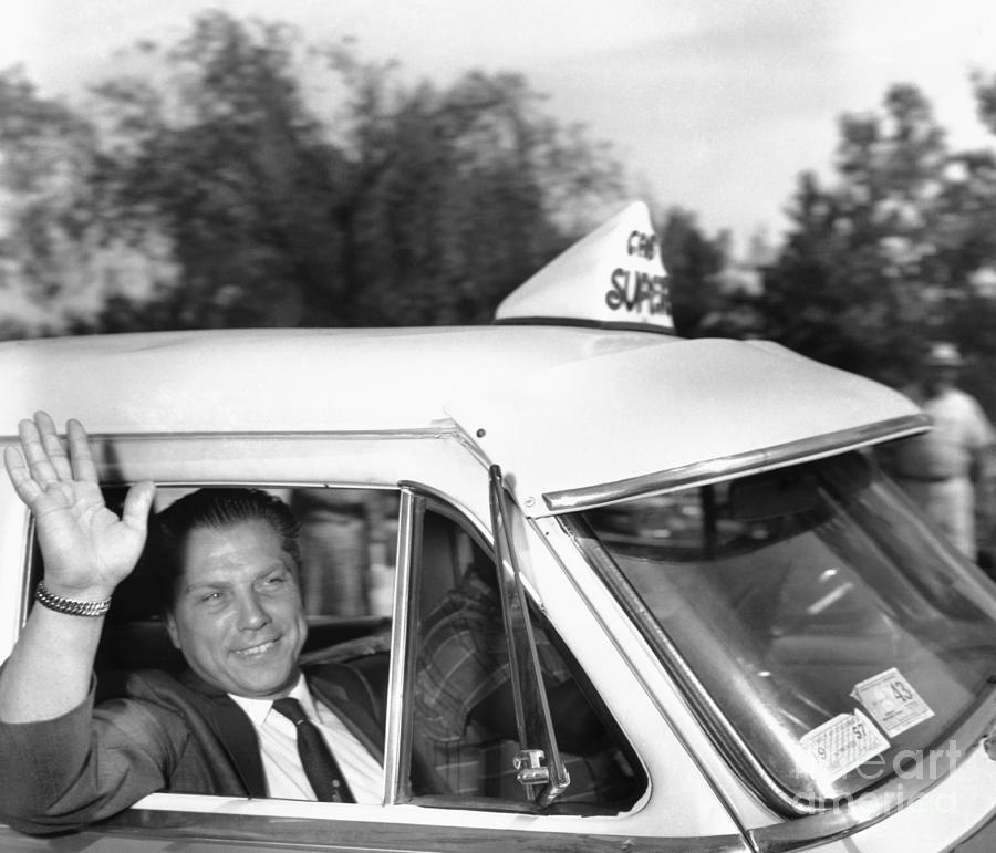 James R. Hoffa Waving From Taxi Photograph by Bettmann