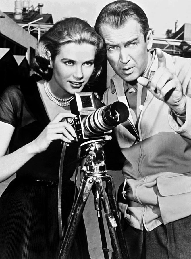 Rear Window Photograph - James Stewart And Grace Kelly Looking Away While Adjusting Camera by Globe Photos