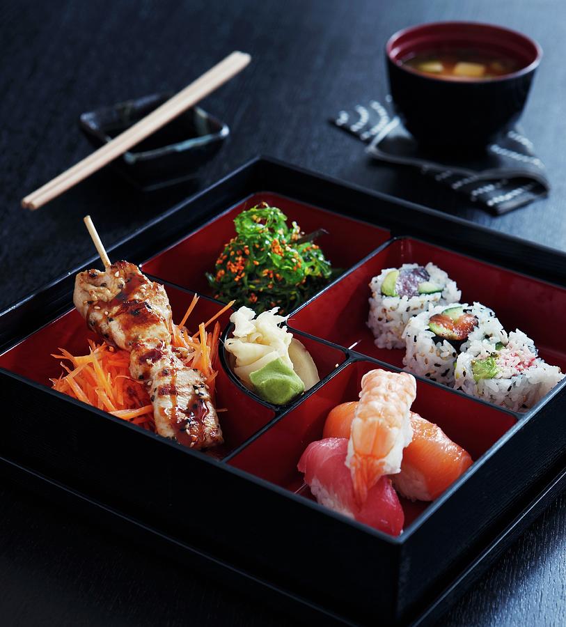 Japanese Food In A Square Varnished Box Photograph by Mikkel Adsbl