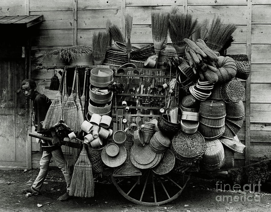 Japanese Man Pulling Cart With Hats Photograph by Bettmann