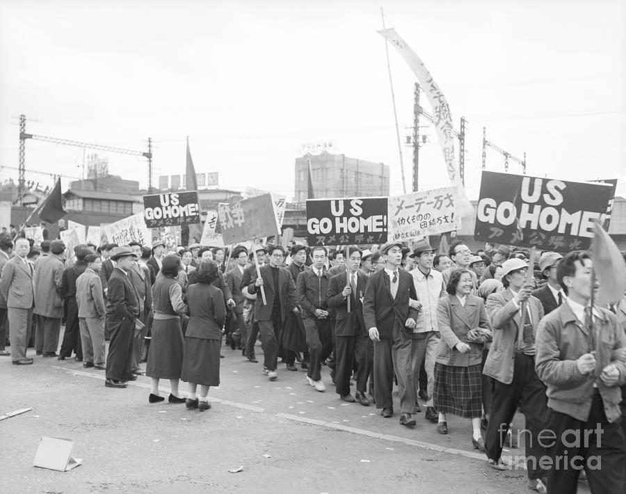 Japanese Marchers With Us Go Home Signs Photograph by Bettmann