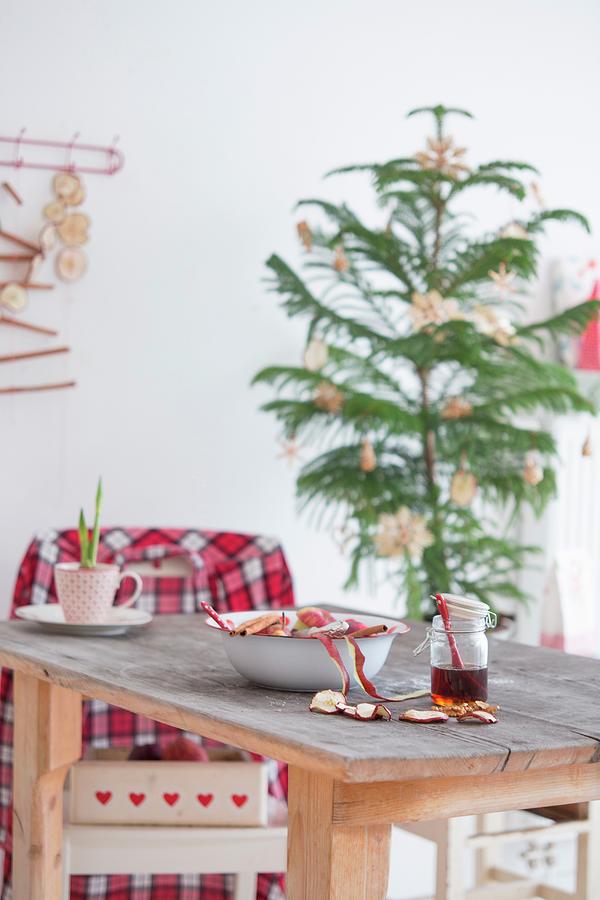 Jar Of Honey, Dried Apple Slices, Bowl And Cups On Wooden Table In Front Of Small Christmas Tree With Straw Stars Photograph by Syl Loves