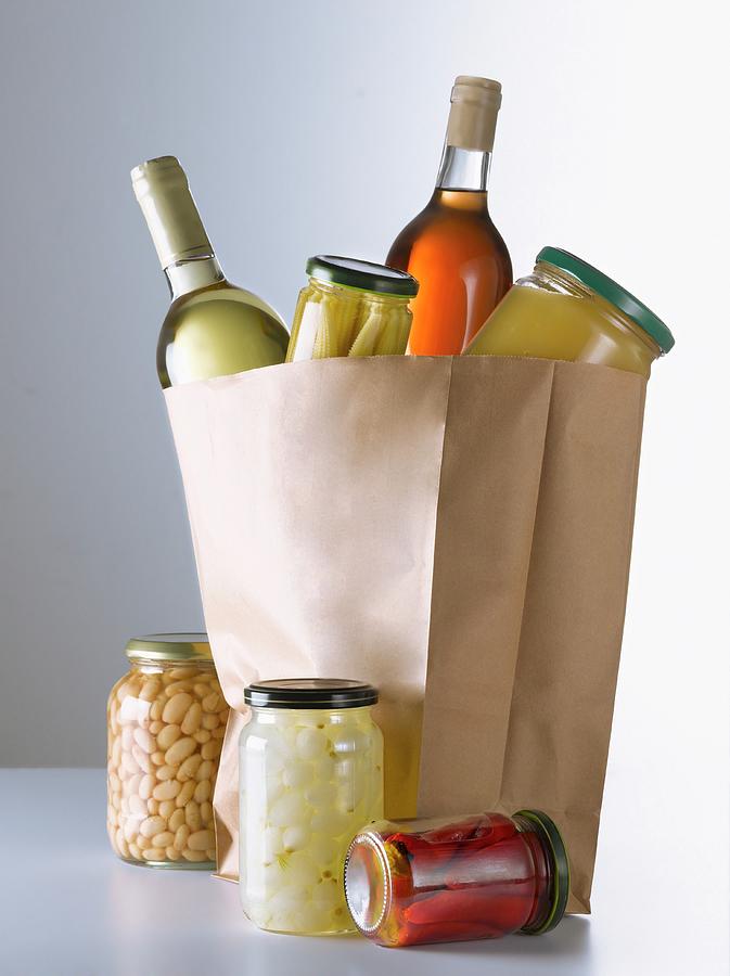 Jars And Bottles In A Brown Paper Bag Photograph by Studio