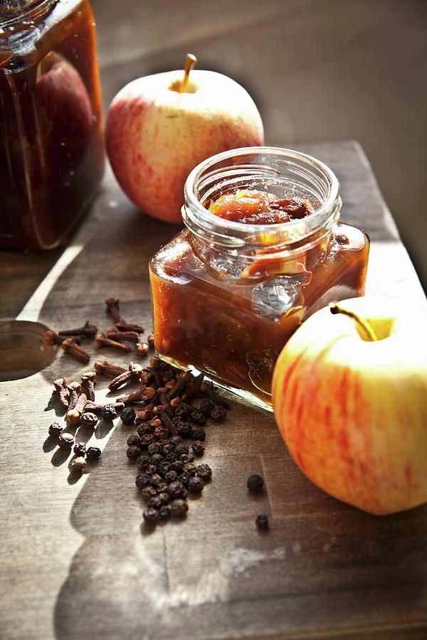 Jars Of Homemade Apple Chutney With Fresh Apples And Spices Photograph by George Blomfield