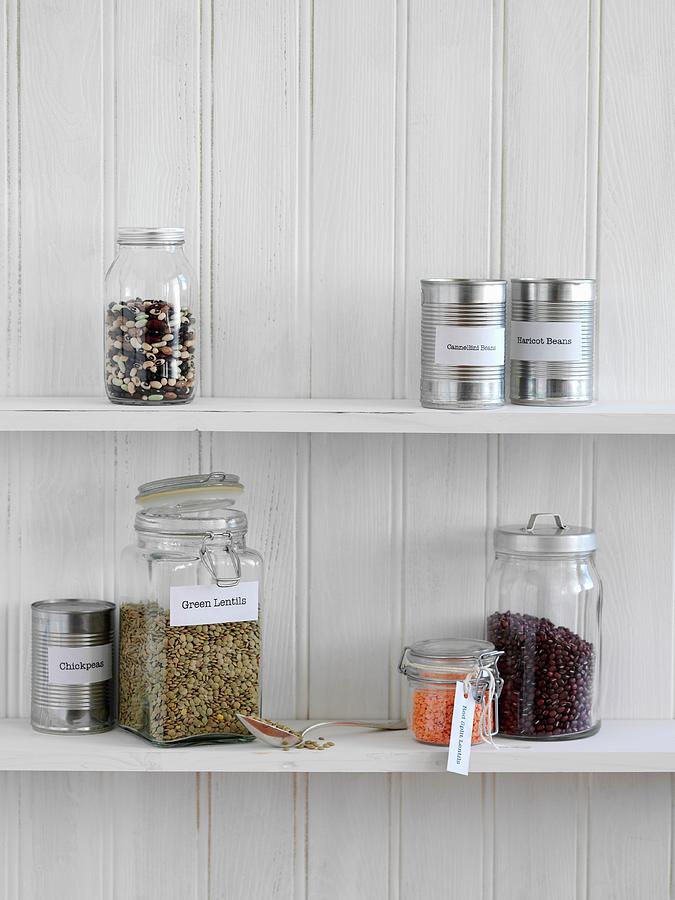 Jars Of Legumes And Tins Of Preserves On A Kitchen Shelf Photograph by Gareth Morgans