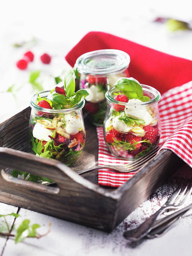 Jars Of Raspberries With Mozzarella And Basil On A Wooden Tray Photograph by Christian Schuster