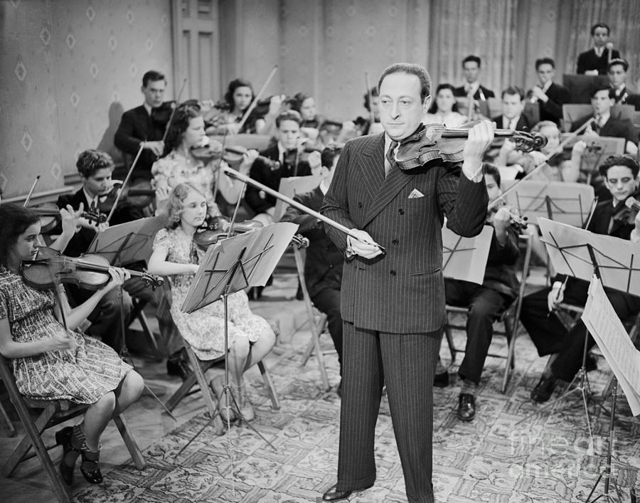Jascha Heifetz With Members Of Orchestra Photograph by Bettmann