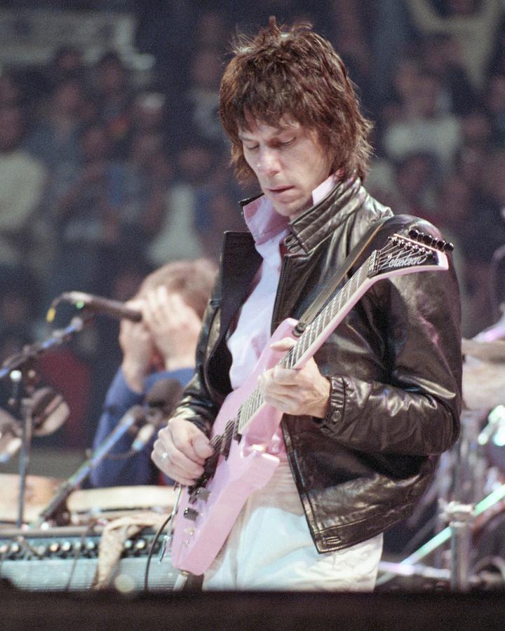 Jeff Beck Photograph - Jeff Beck Looking At His Guitar On Stage At Arms Charity Concerts by Globe Photos
