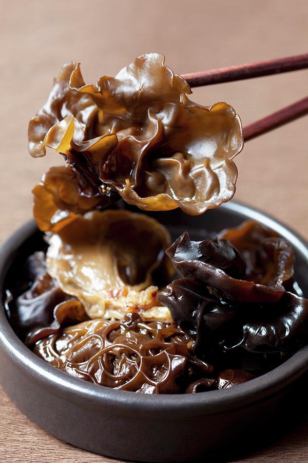 Jelly Ear Fungus In A Bowl And On Chopsticks Photograph by Hilde Mche