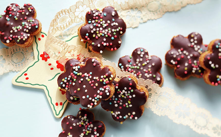 Jelly-filled Almond Flowers With Chocolate Glaze And Sugar Sprinkles Photograph by Teubner Foodfoto