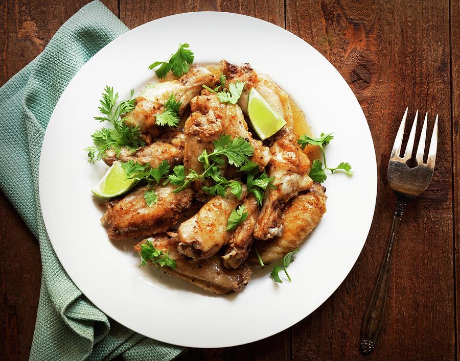 Jerk Chicken Wings With Lime Wedges And Coriander Photograph by George Crudo
