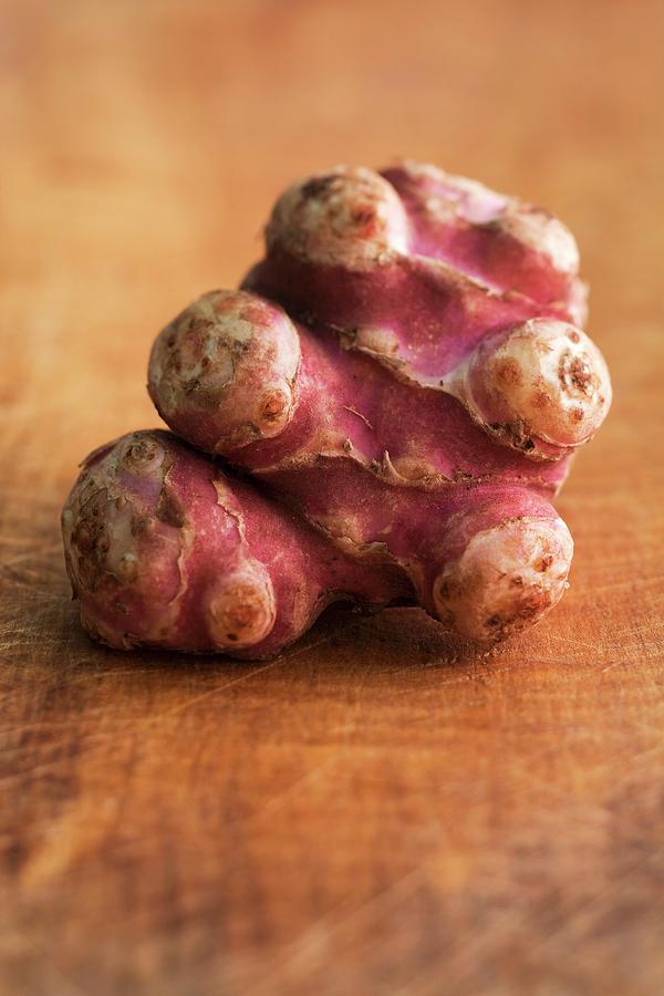 Jerusalem Artichokes On Wooden Background Photograph by Michael Wissing