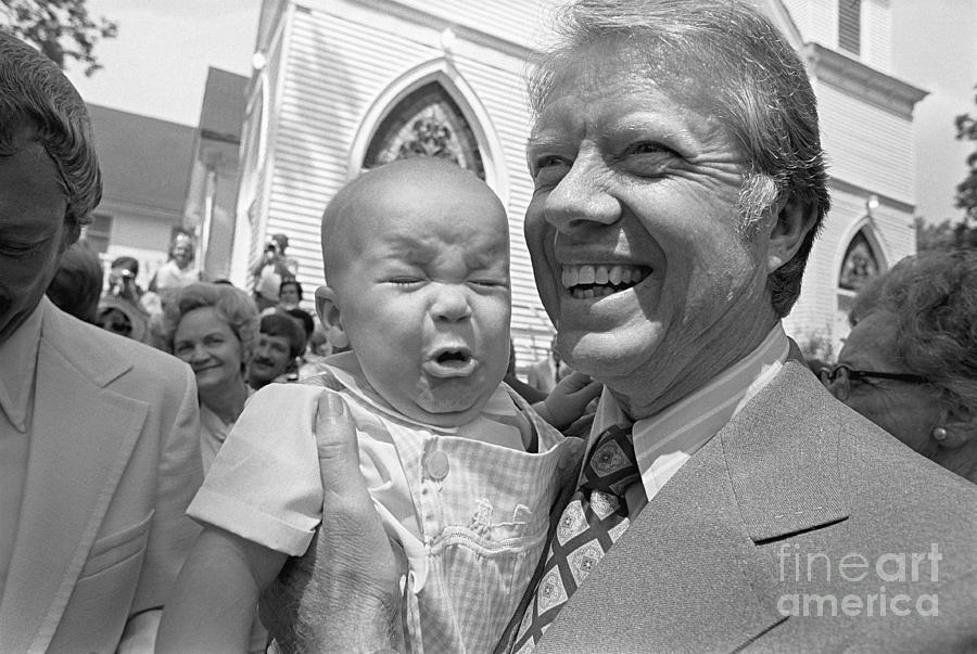 Jimmy Carter Holds Crying Baby Photograph by Bettmann