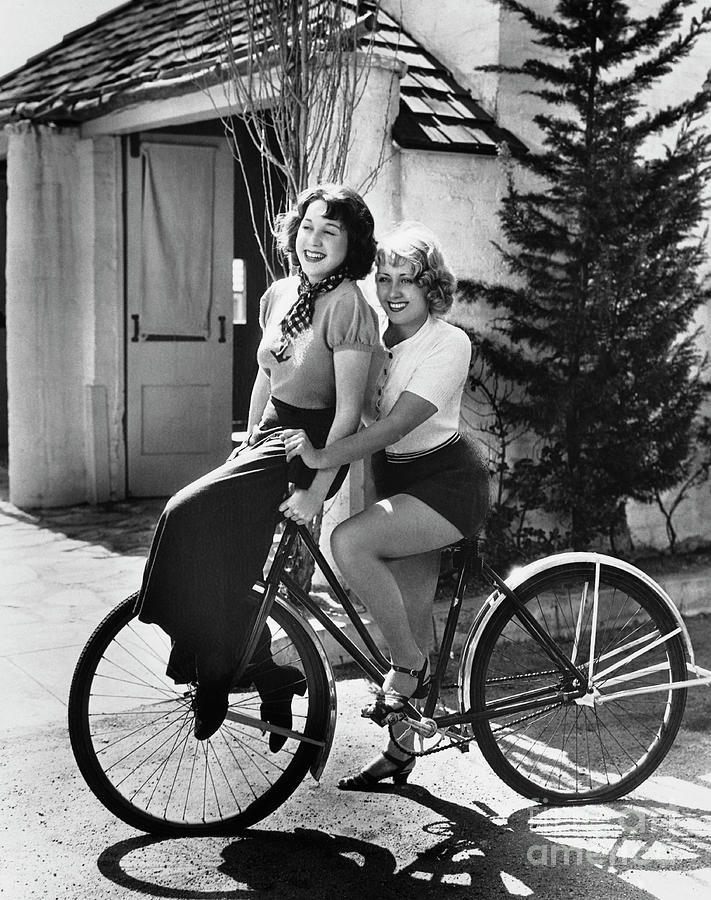 Joan Blondell And Sister Riding Bicycle Photograph by Bettmann
