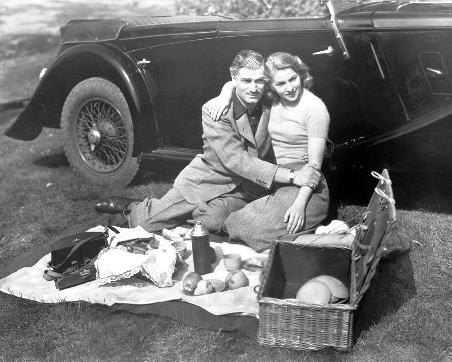 Joan Fontaine And Laurence Olivier Sitting On Grass Photograph by Globe ...