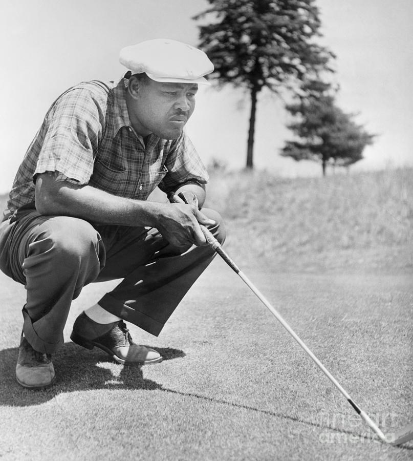 Joe Louis Stooping To Examine Golf Photograph by Bettmann