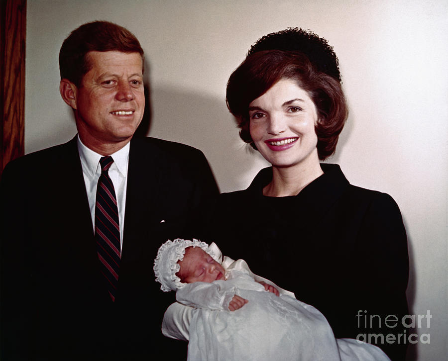 John F Kennedy Photograph - John F Kennedy With Jackie Holding Son by Bettmann