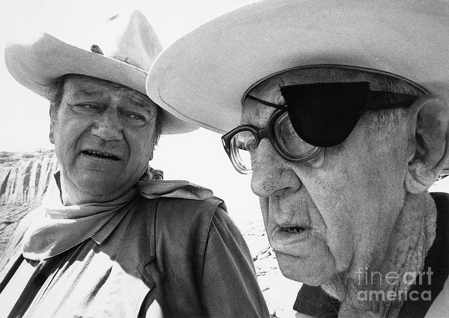 John Ford And John Wayne Talking Photograph by Bettmann