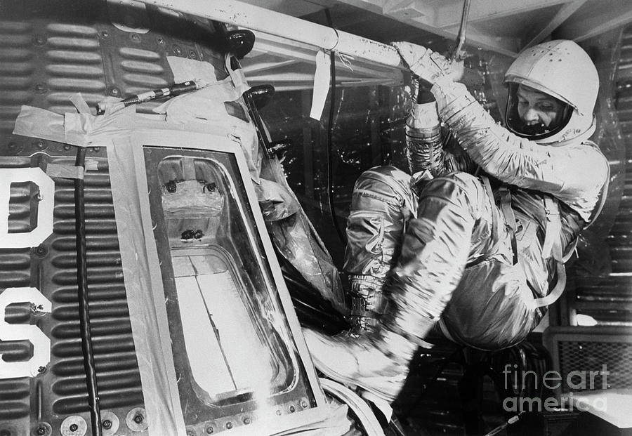 John Glenn Climbing Into Space Capsule Photograph by Bettmann