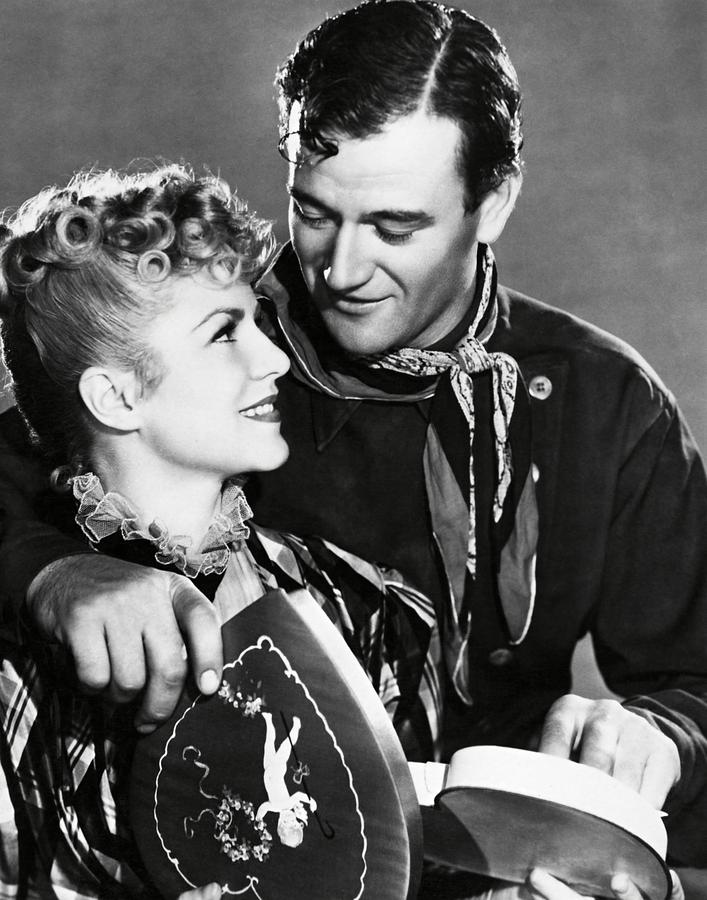 JOHN WAYNE and CLAIRE TREVOR in STAGECOACH -1939-. Photograph by Album