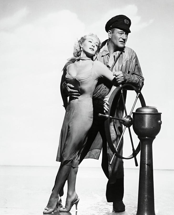 JOHN WAYNE and LANA TURNER in THE SEA CHASE -1955-. Photograph by Album