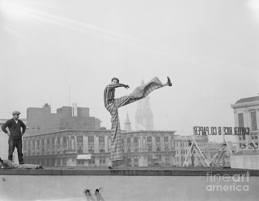 Joseph De Vigilio On Stilts On Rooftop Photograph by Bettmann