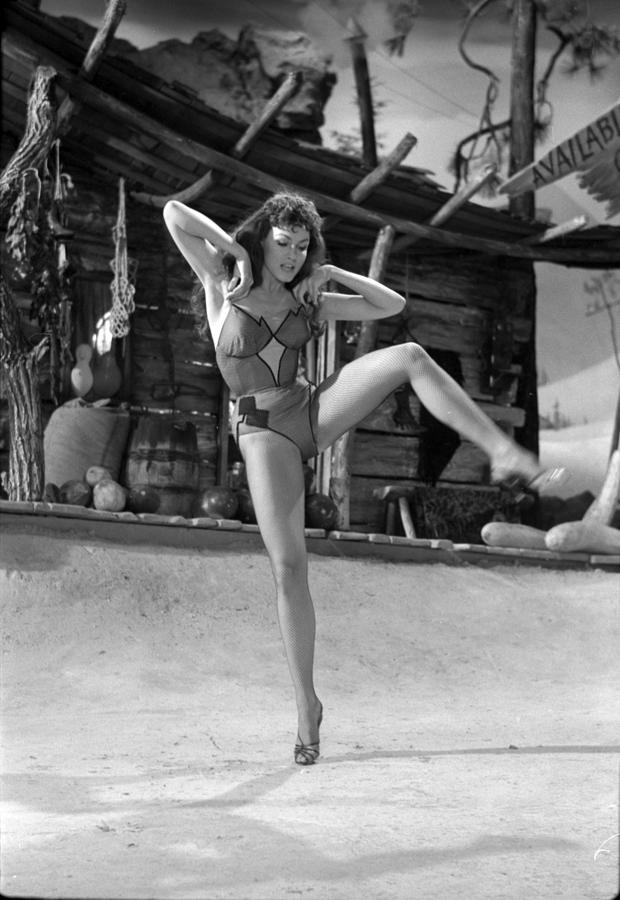 Black And White Photograph - Julie Newmar Standing On One Foot by Don Ornitz