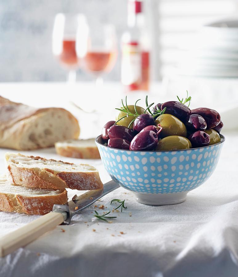 Kalamata Olives And Green Olives With Bread And Rose Wine On A Laid Table Photograph by Ludger Rose