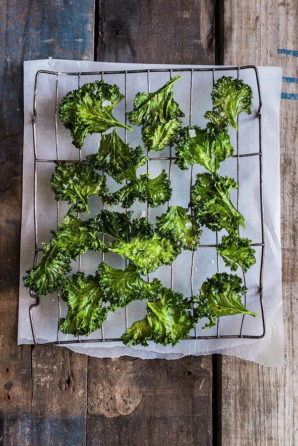 Kale Chips On A Wire Rack Photograph by Hein Van Tonder