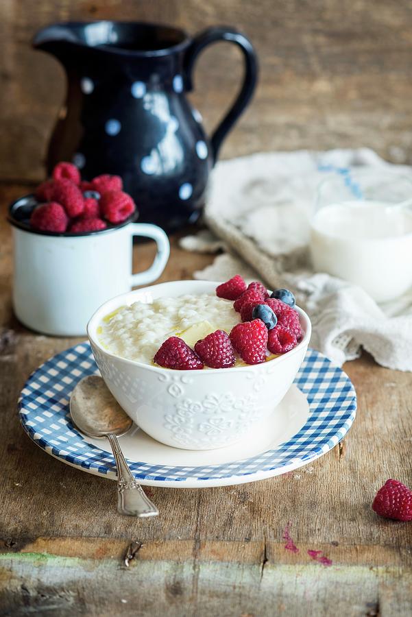 Kascha russian Rice Porridge With Butter, Raspberries Blueberries And Milk Photograph by Irina Meliukh