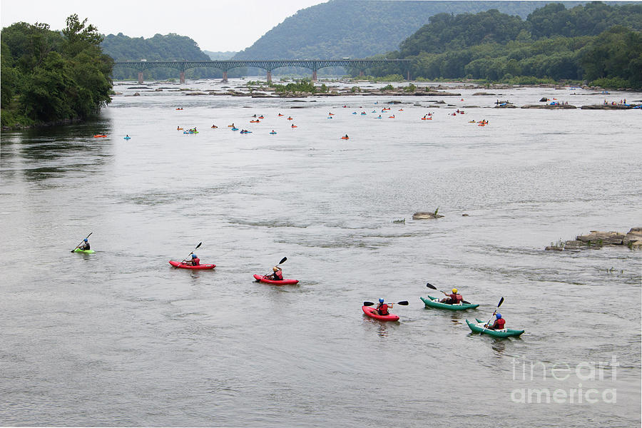 Kayakers and tubers ride the Shenandoah river into the Potomac a Photograph by William Kuta