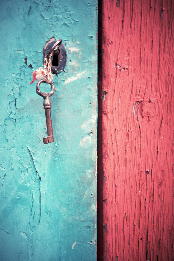 Key In Old Wooden Door Photograph by Johner Images