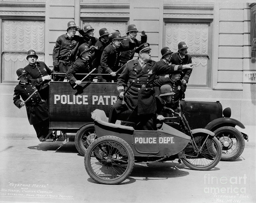 Keystone Kops Riding Patrol Wagons Photograph by Bettmann
