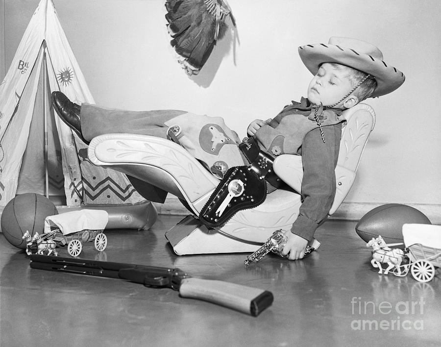 Kid In Cowboy Outfit Sleeps In Contour by Bettmann