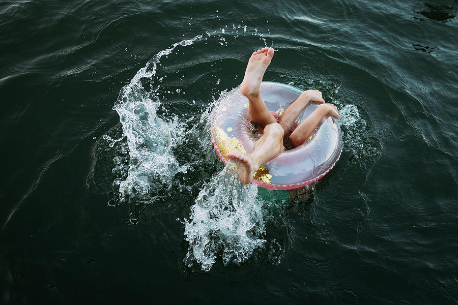 Summer Photograph - Kids Limbs Sticking Out Of Swim Float In Lake by Cavan Images / Krista Taylor