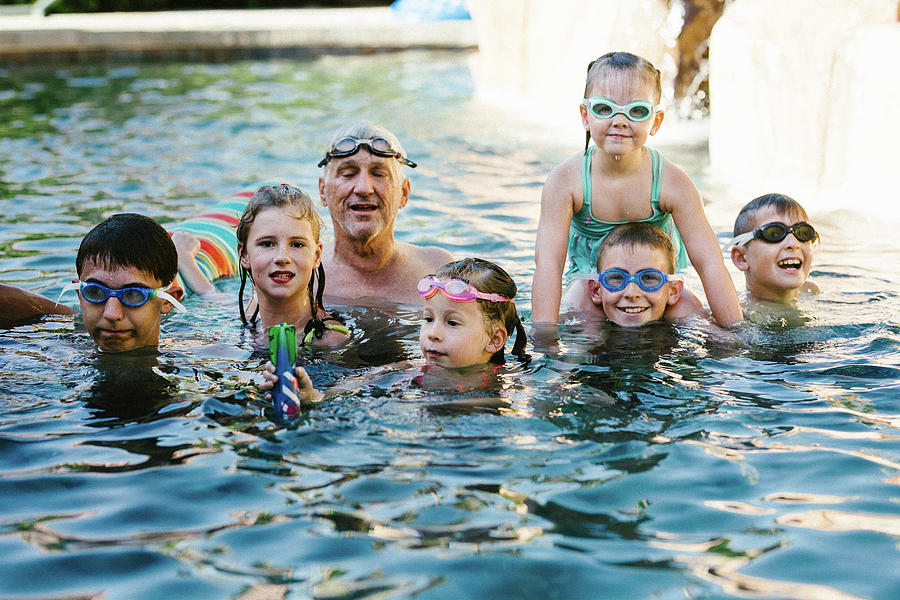 Kids Play And Splash In Swim Pool With Grandpa In Summer Photograph By 