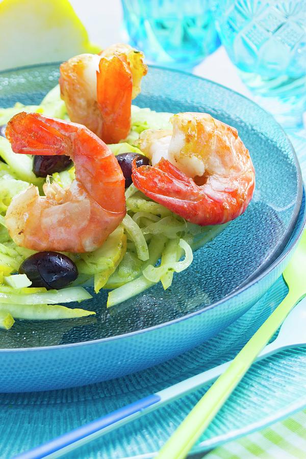 King Prawns On A Lemon And Fennel Salad With Black Olives On A Glass Turquoise Plate Photograph by Charlotte Von Elm